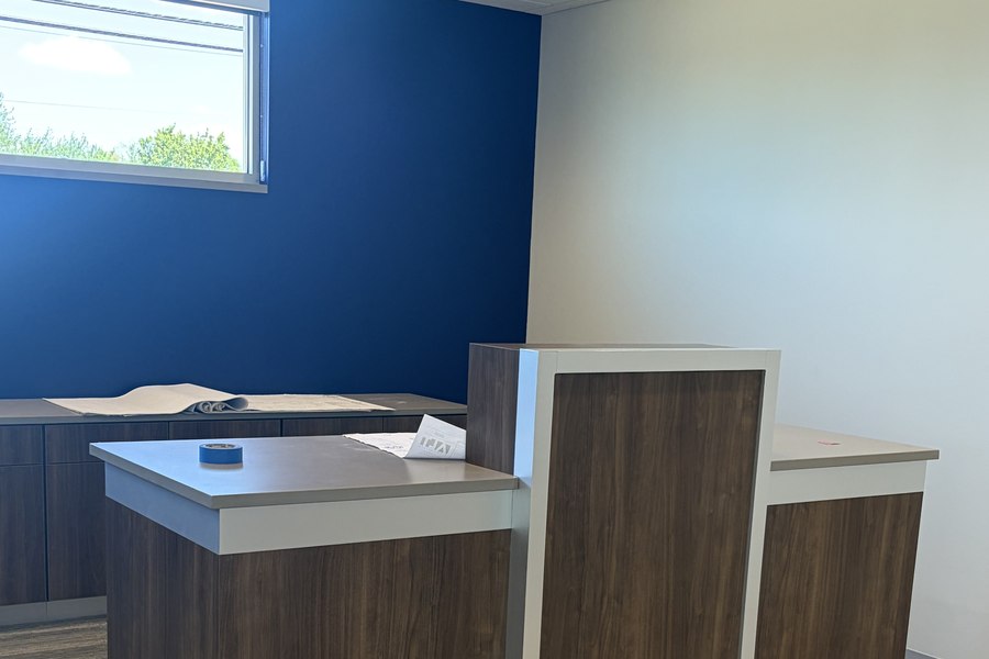 Bank teller station close-up dark walnut and white countertop by Robertson Cabinets
