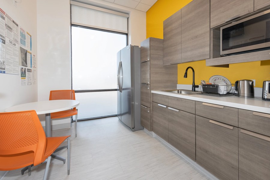 Office break room casework with yellow accent wall modern cabinets by Robertson Cabinets