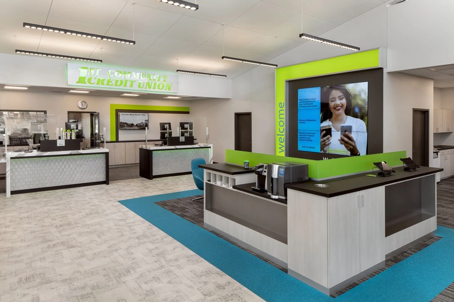 Credit union full lobby with greeter kiosk and digital signage wall by Robertson Cabinets