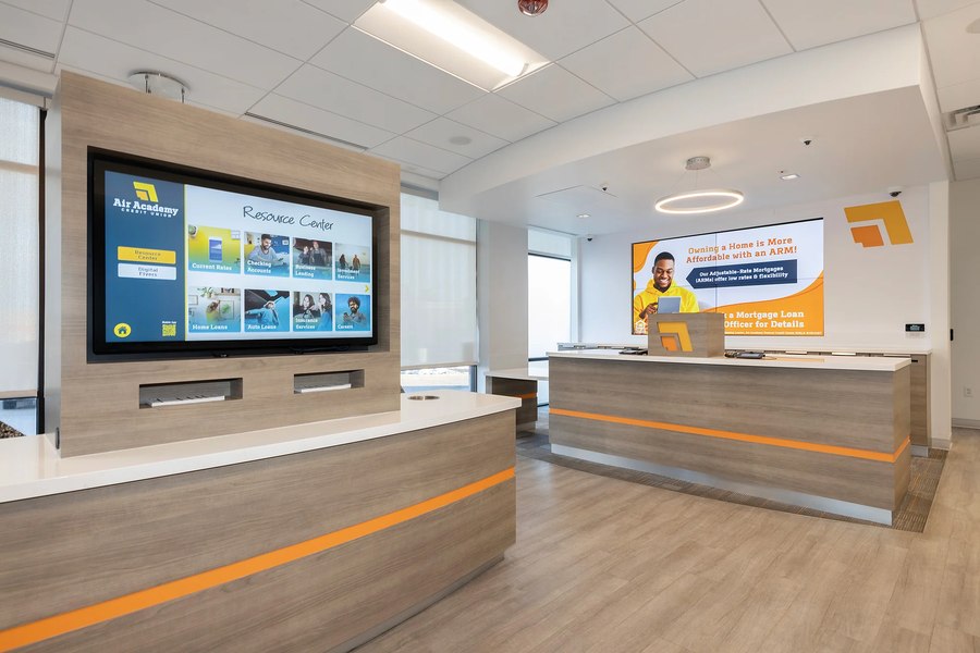 Credit union double teller and greeter stations with digital display walls by Robertson Cabinets