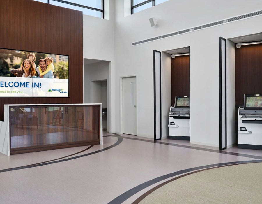 Bank teller line installation dark walnut with gray countertops by Robertson Cabinets