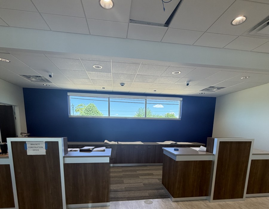 Bank teller line custom casework dark walnut and gray by Robertson Cabinets