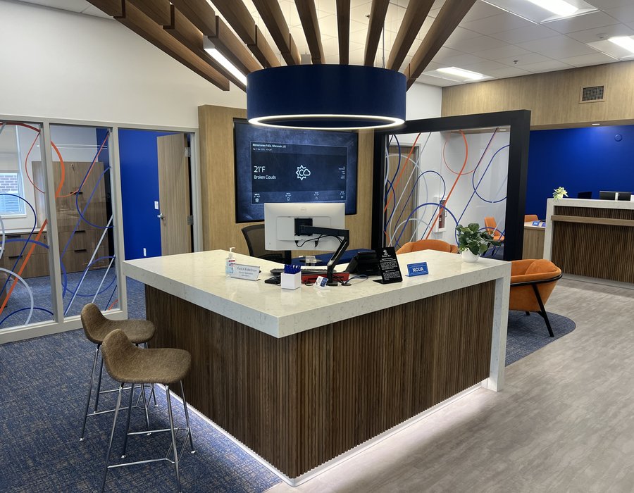Credit union teller line with fluted walnut fascia and quartz countertop by Robertson Cabinets