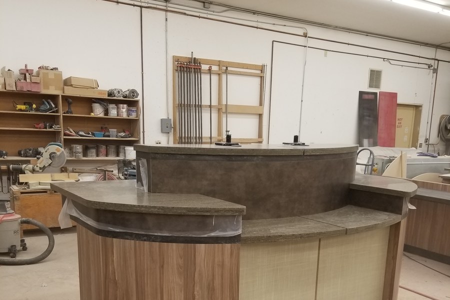 Curved reception desk being built in Robertson Cabinets production facility Ohio