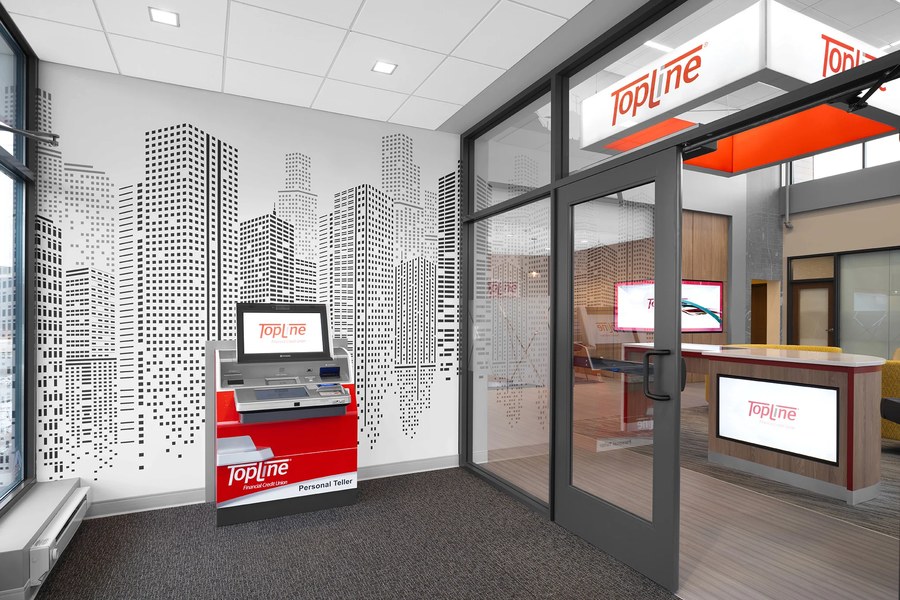 Credit union branch entrance with teller kiosk and branded wall graphics by Robertson Cabinets